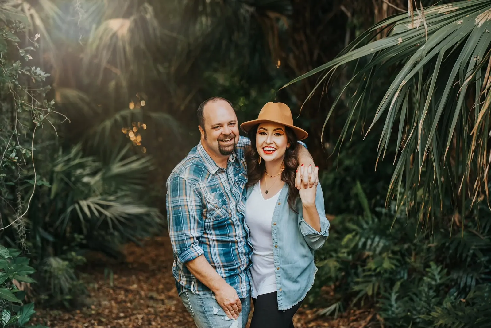 Michael and Michelle Blair laughing together among palm trees